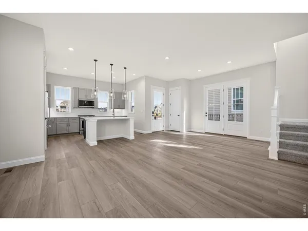 a view of kitchen with wooden floor and electronic appliances