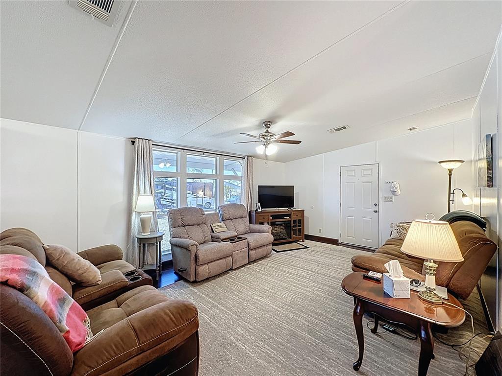 251 Patterson Road, Unit I3 Haines City, FL 33844 - Photo 13 of 38 a living room with furniture or couch and a flat screen tv