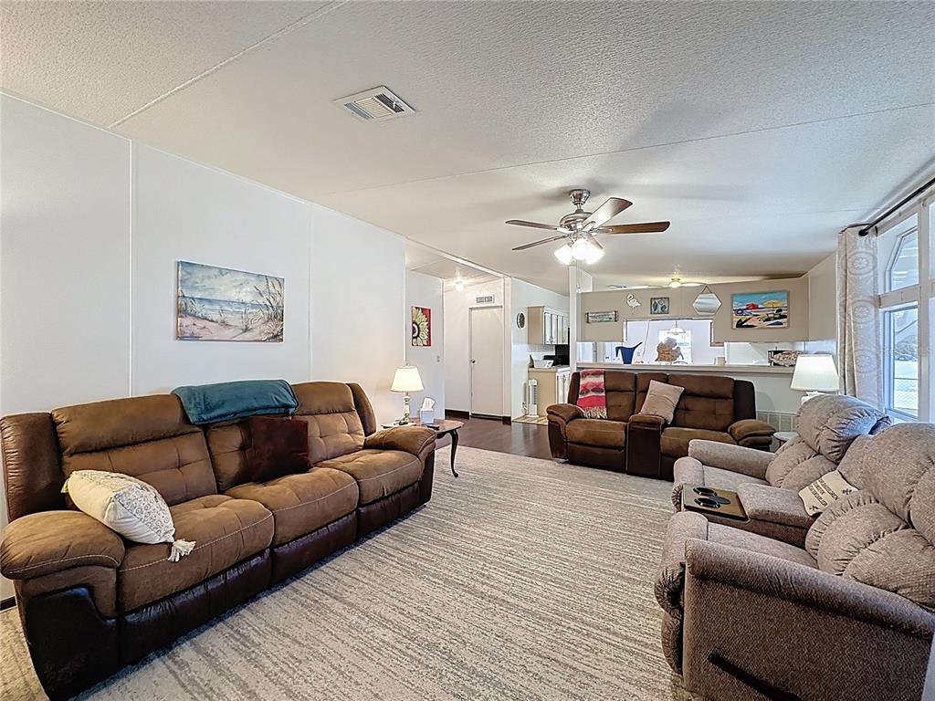 251 Patterson Road, Unit I3 Haines City, FL 33844 - Photo 16 of 38 a living room with furniture and a wooden floor