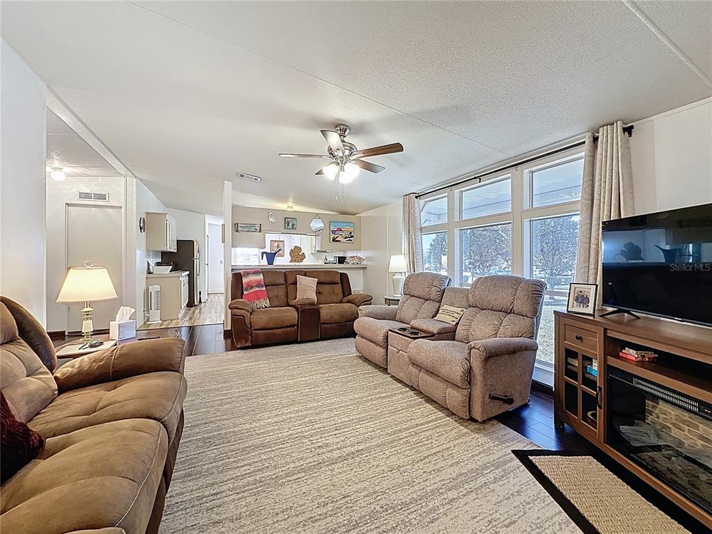 251 Patterson Road, Unit I3 Haines City, FL 33844 - Photo 17 of 38 a living room with furniture a flat screen tv and a fireplace