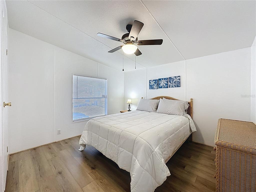 251 Patterson Road, Unit I3 Haines City, FL 33844 - Photo 18 of 38 a bedroom with bed and a chandelier