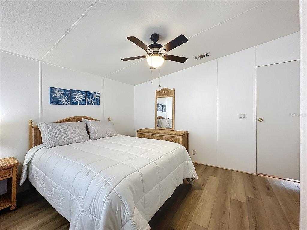 251 Patterson Road, Unit I3 Haines City, FL 33844 - Photo 19 of 38 a bedroom with a large bed and a ceiling fan