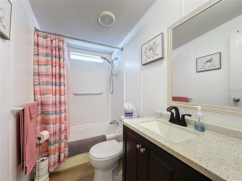 251 Patterson Road, Unit I3 Haines City, FL 33844 - Photo 21 of 38 a bathroom with a granite countertop sink toilet and shower