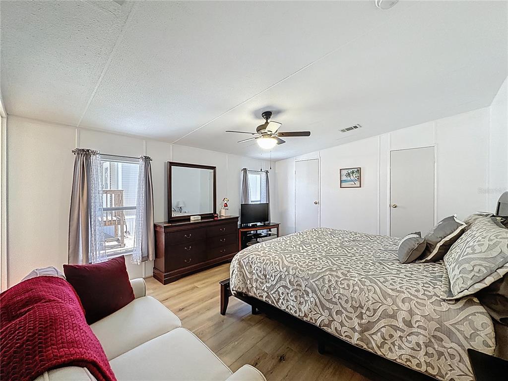 251 Patterson Road, Unit I3 Haines City, FL 33844 - Photo 22 of 38 a bedroom with a bed and a couch