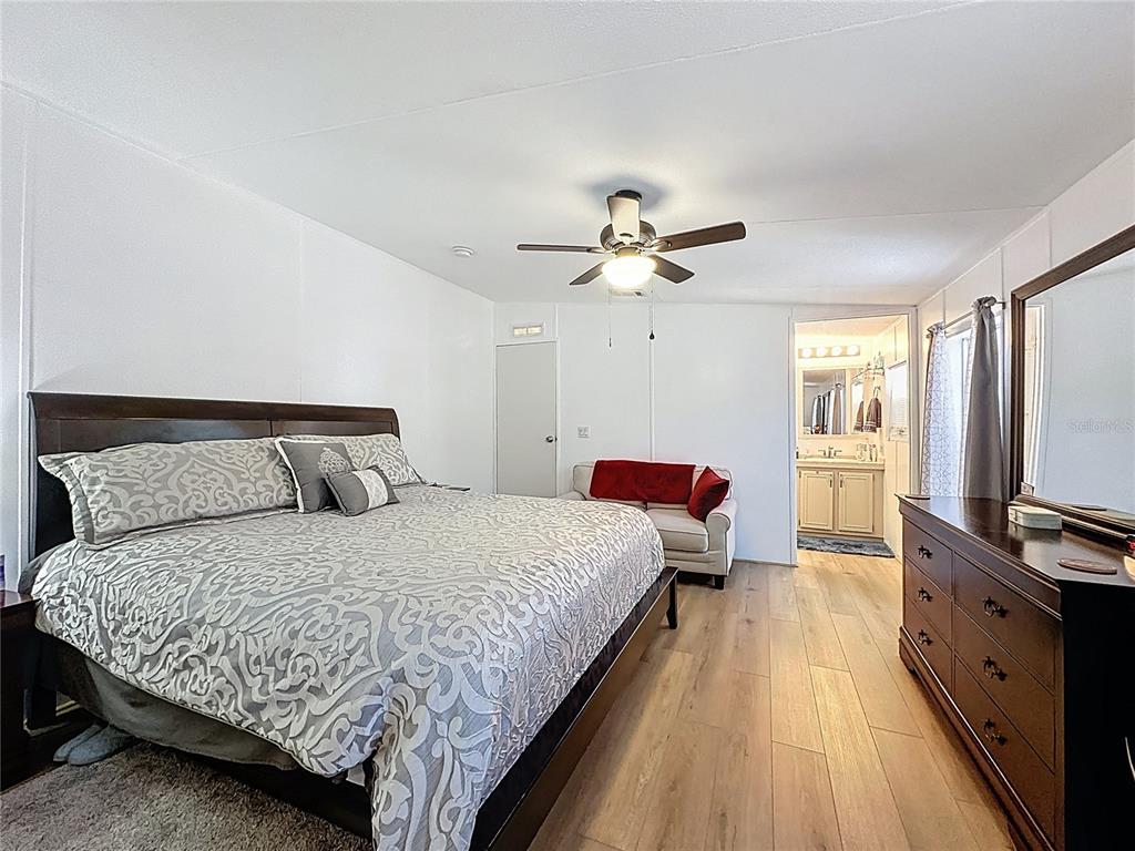 251 Patterson Road, Unit I3 Haines City, FL 33844 - Photo 24 of 38 a bedroom with a large bed and a flat tv screen on dresser