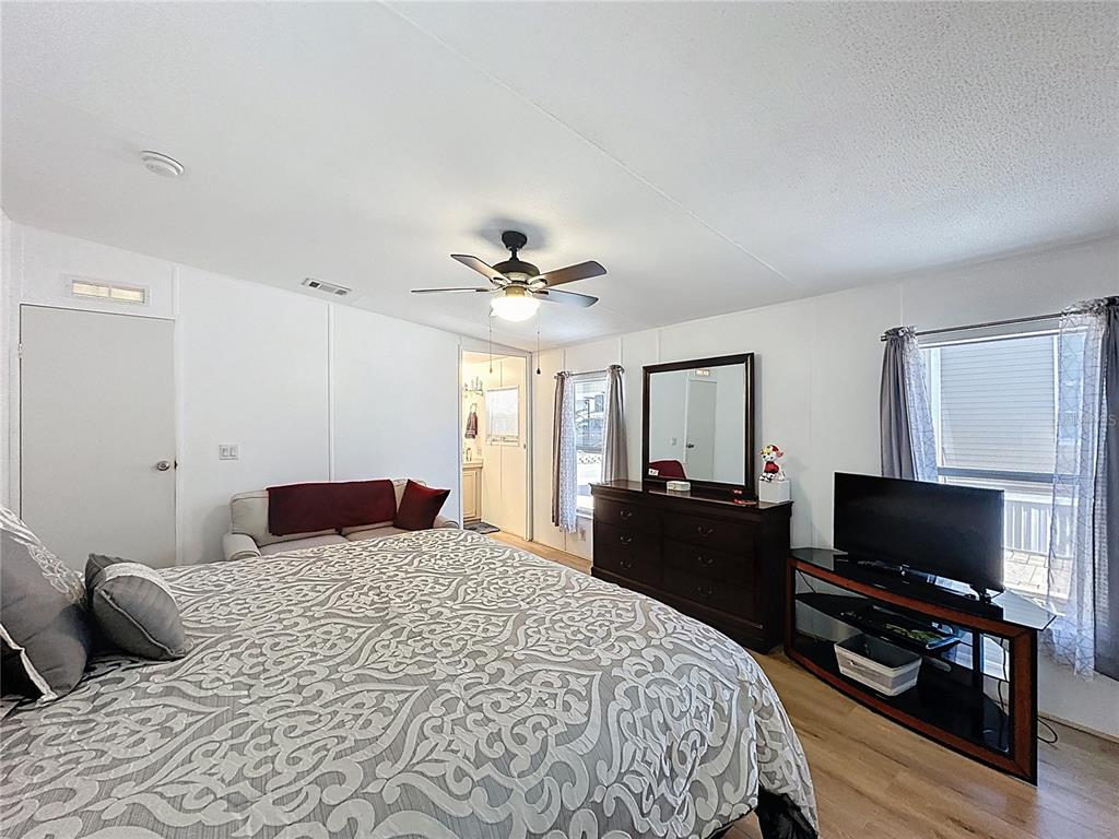 251 Patterson Road, Unit I3 Haines City, FL 33844 - Photo 25 of 38 a bedroom with a bed and a flat screen tv