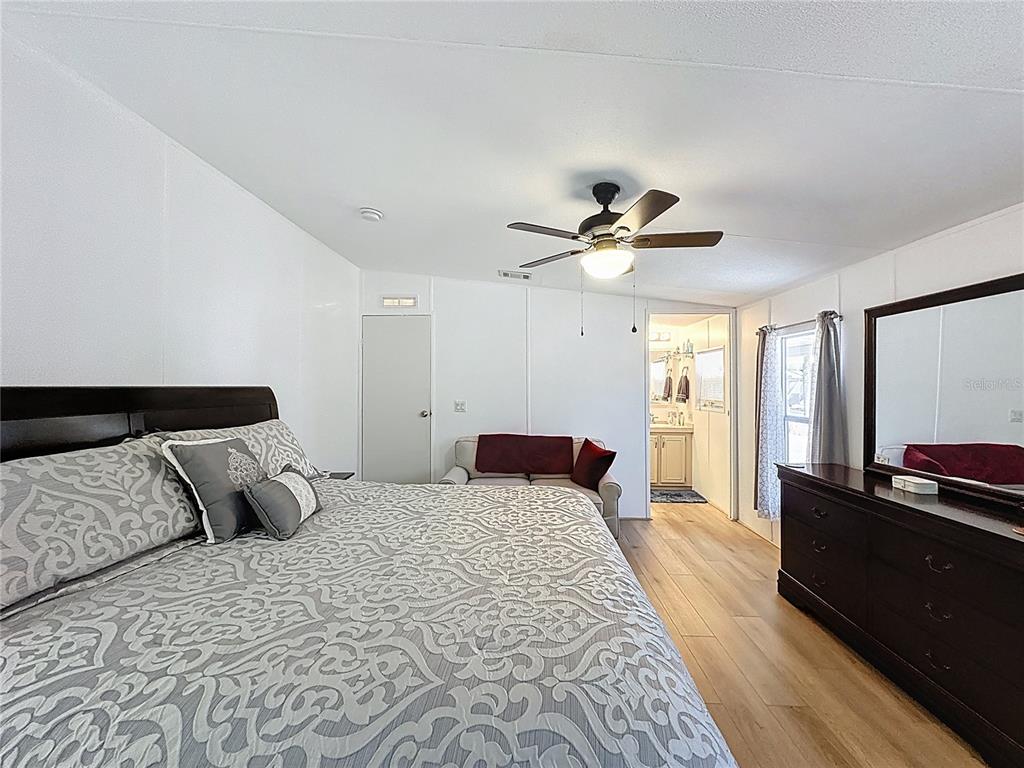 251 Patterson Road, Unit I3 Haines City, FL 33844 - Photo 26 of 38 a bedroom with a bed and wooden floor