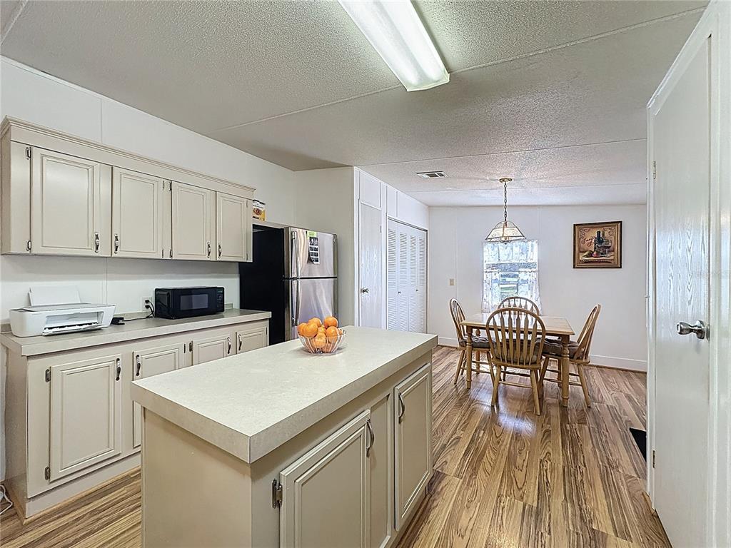 251 Patterson Road, Unit I3 Haines City, FL 33844 - Photo 5 of 38 a kitchen with a stove a table and chairs in it