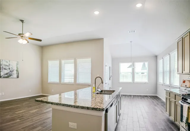a kitchen with stainless steel appliances granite countertop a stove and a microwave