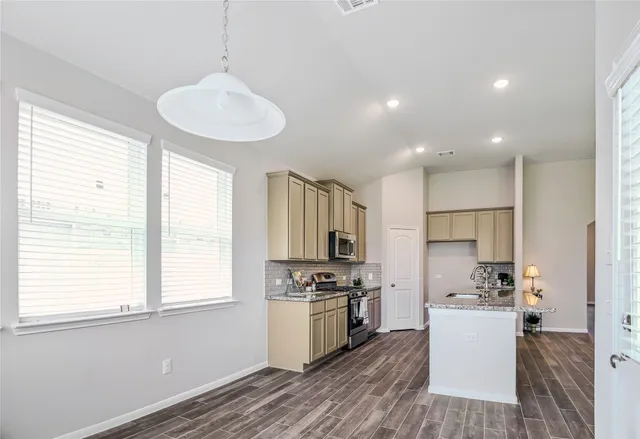 a bathroom with double vanity sinks a vanity a lamp and a mirror
