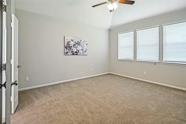 an empty room with fan and window