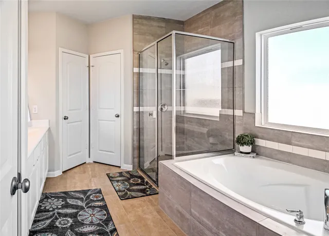 a bathroom with a bathtub and a shower