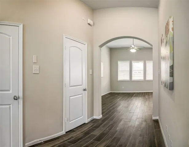 a view of a hallway view with wooden floor and staircase