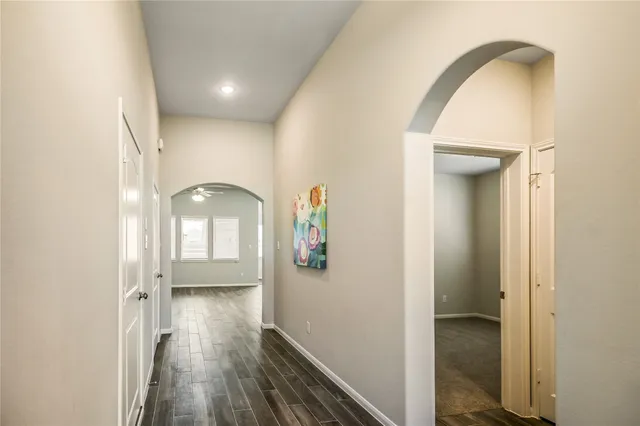 a view of a kitchen with a refrigerator cabinets and wooden floor