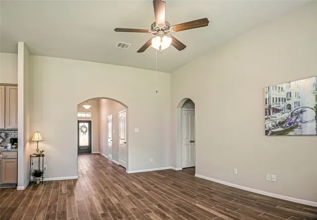 a view of a kitchen with wooden floor electronic appliances and window