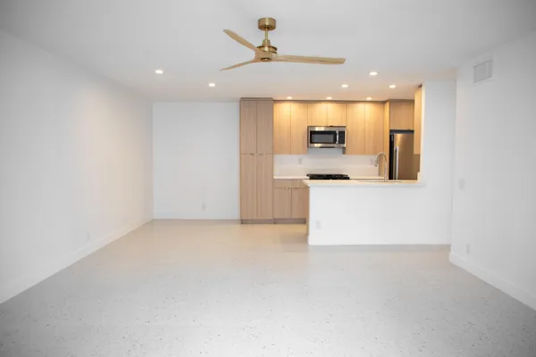 an empty room with a kitchen and a sink