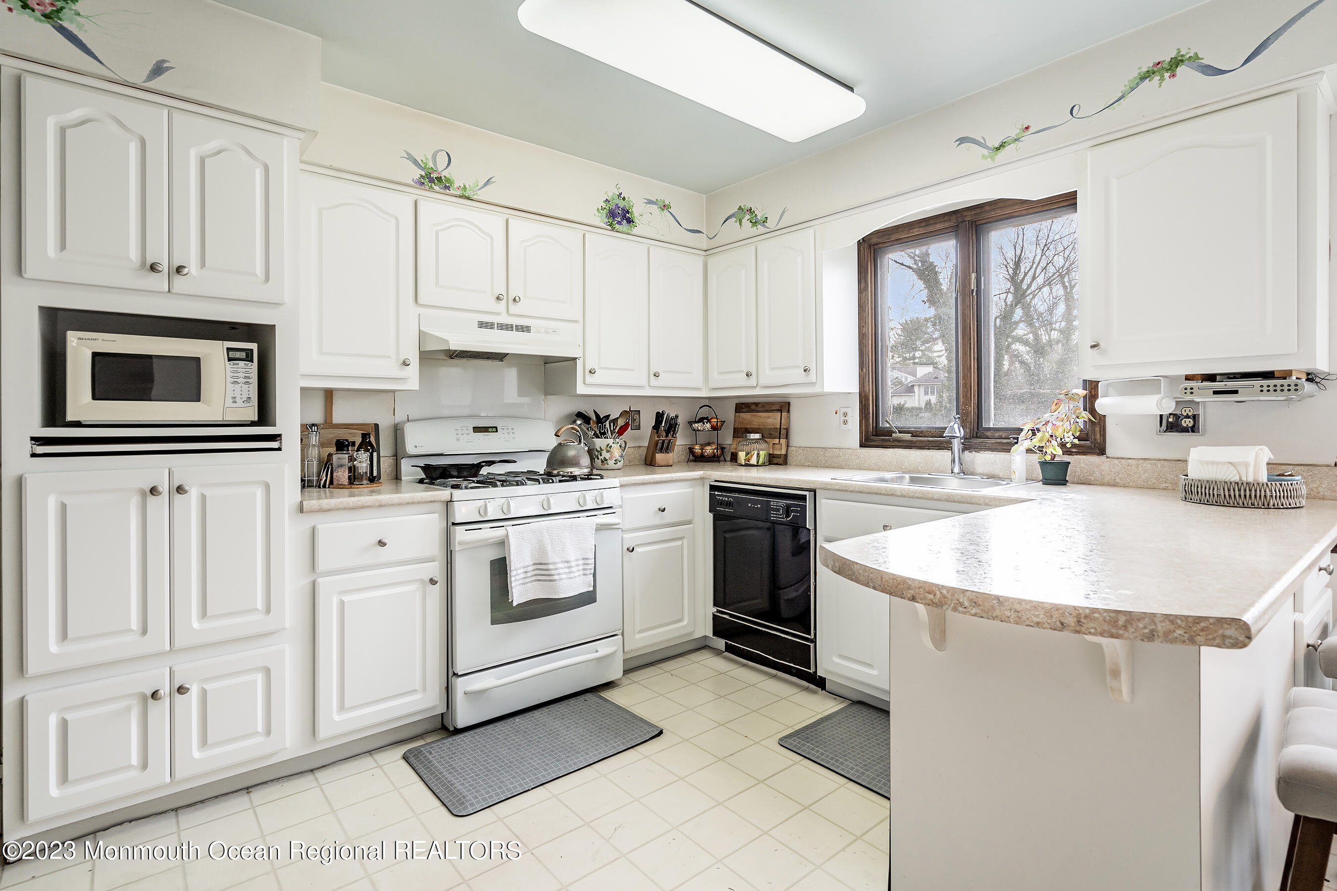 7 Pirates Cove Road Little Silver, NJ 07739 - Photo 8 of 41 a kitchen with white cabinets and white appliances