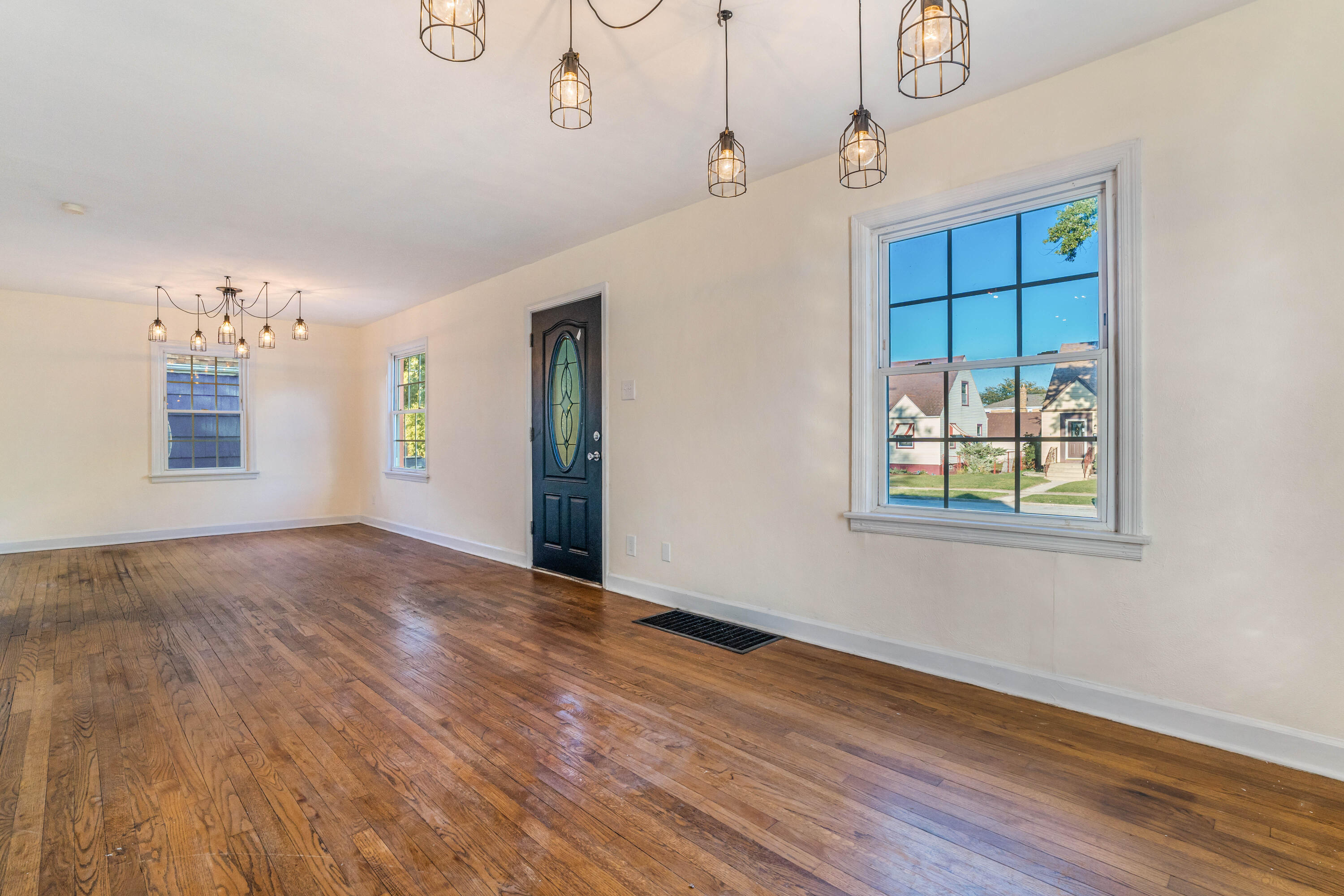 6734 Baring Avenue Hammond, IN 46324 - Photo 3 of 22 a view of an empty room with window and wooden floor