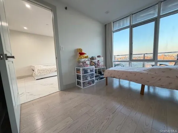 a bedroom with a bed and a mirror on dresser