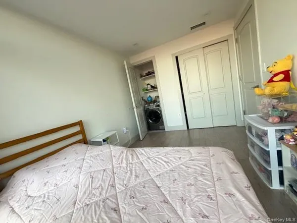 a living room with a floor to ceiling window and wooden floor