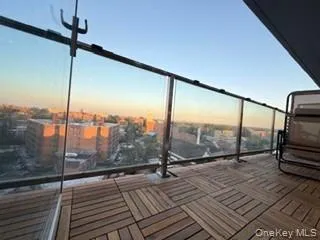 a view of a balcony with wooden floor and city view