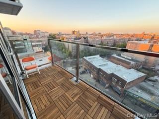 41-62 Bowne Street, Unit 9F Queens, NY 11355 - Photo 21 of 25 a view of a balcony with wooden floor and city view