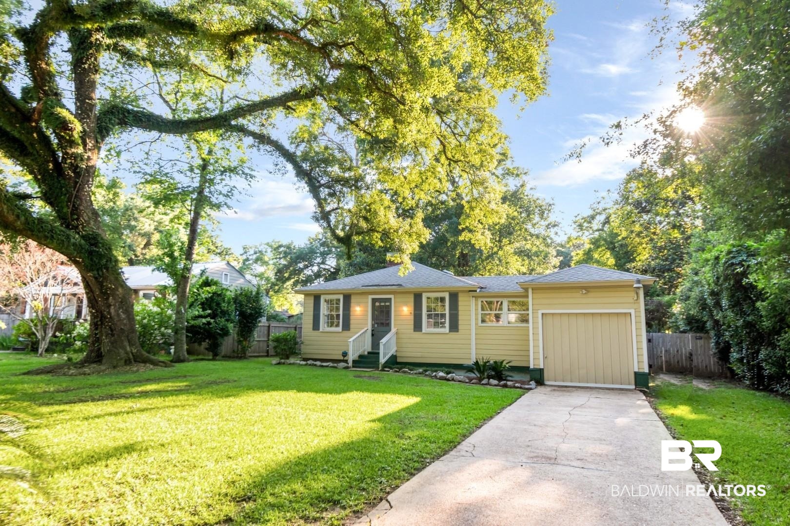 263 Border Drive East Mobile, AL 36608 - Photo 27 of 27 Ranch-style exterior with a light yellow facade, dark green shutters, and a single-car garage