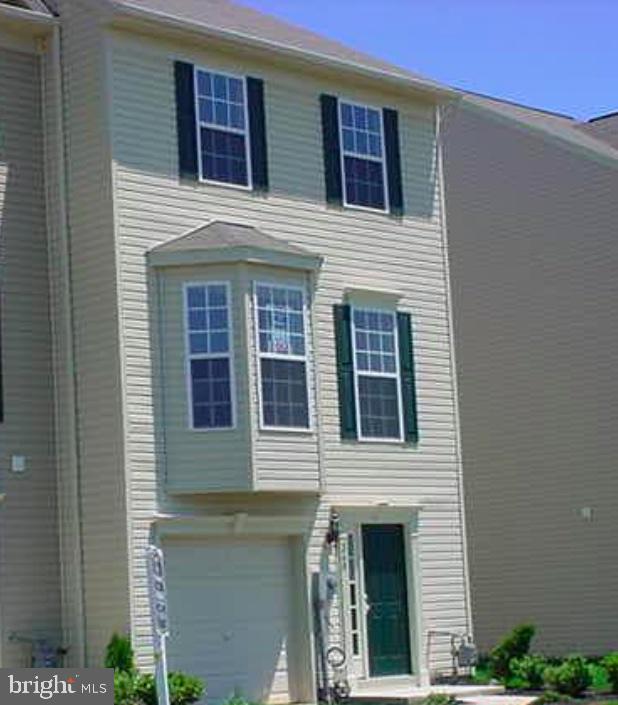 a view of a house with more windows and brick walls