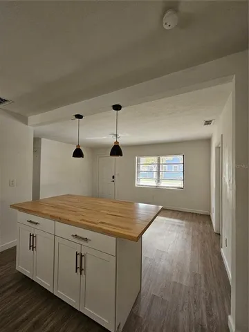a kitchen with a wooden floor and white appliances