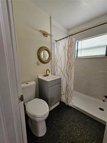 a bathroom with a toilet sink and shower