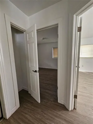 a view of a hallway with wooden floor