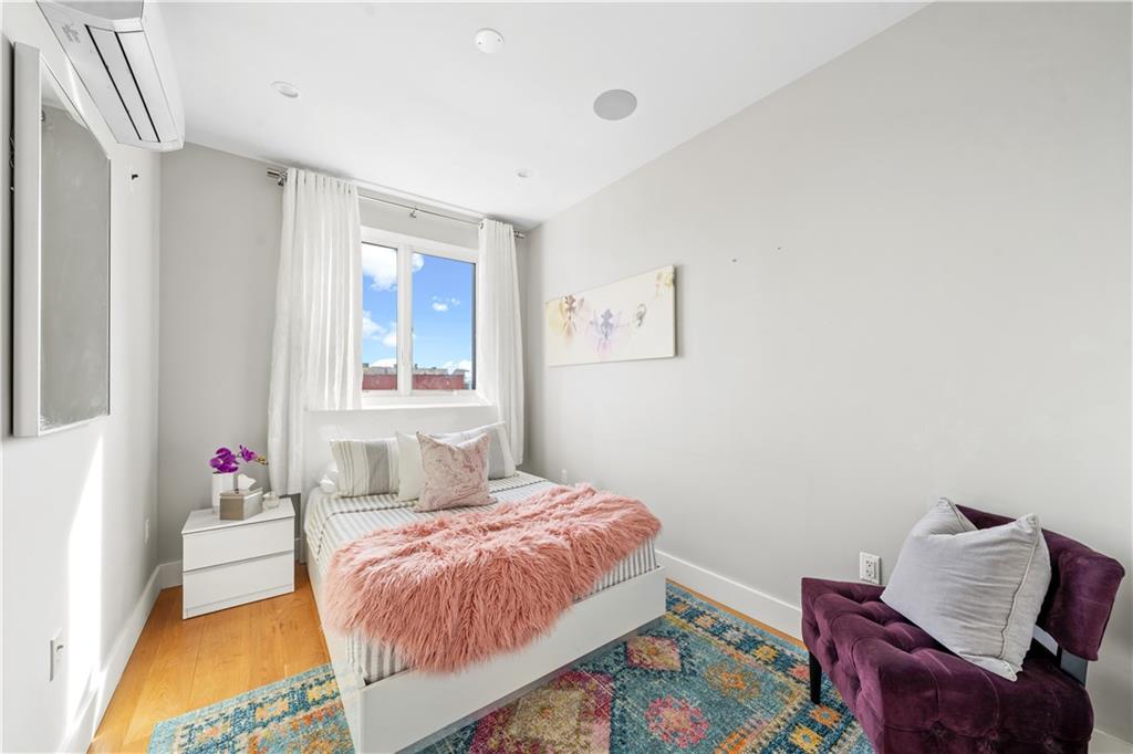139 Grove Street, Unit 4F Brooklyn, NY 11221 - Photo 15 of 23 a bedroom with a bed and window