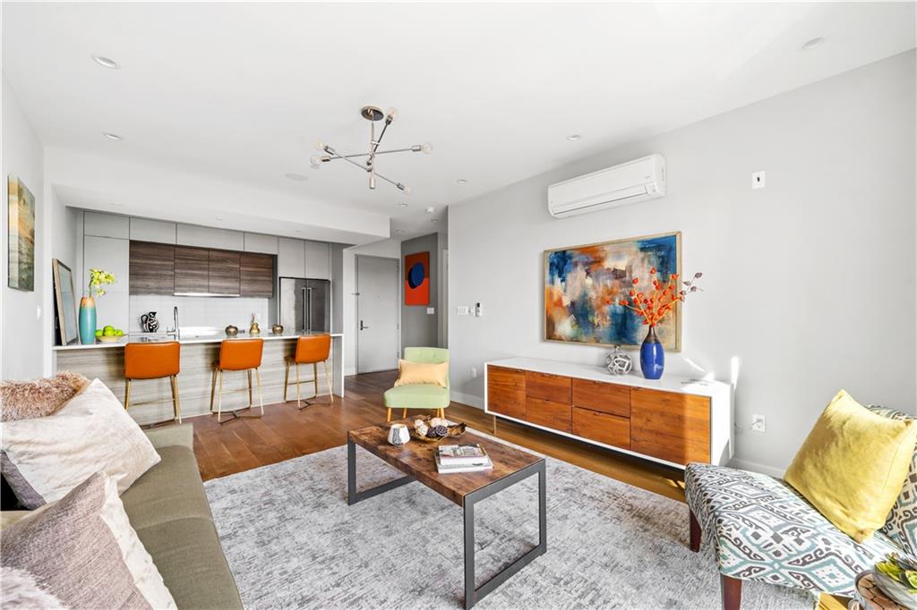 139 Grove Street, Unit 4F Brooklyn, NY 11221 - Photo 5 of 23 a living room with furniture kitchen view and a table