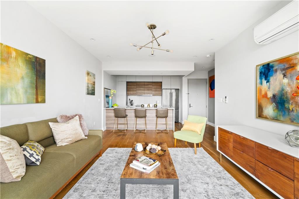 139 Grove Street, Unit 4F Brooklyn, NY 11221 - Photo 6 of 23 a living room with furniture and a rug