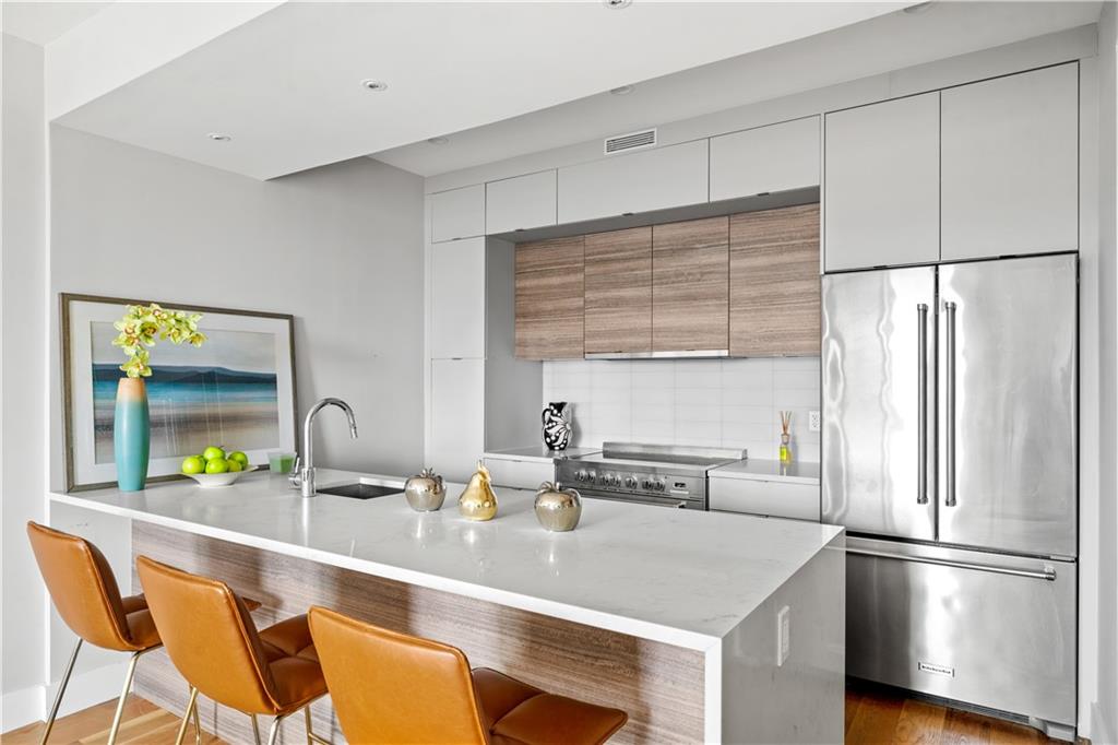 139 Grove Street, Unit 4F Brooklyn, NY 11221 - Photo 7 of 23 a kitchen with stainless steel appliances a sink and a refrigerator