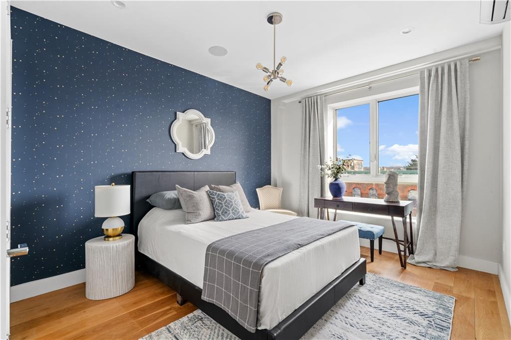 139 Grove Street, Unit 4F Brooklyn, NY 11221 - Photo 10 of 23 a bedroom with bed and wooden floor