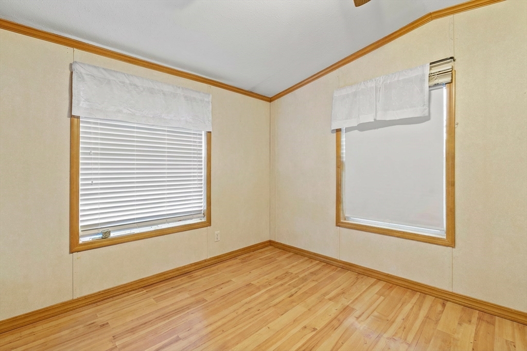 45 Kins Court Wareham, MA 02558 - Photo 12 of 16 a view of an empty room with wooden floor and a window