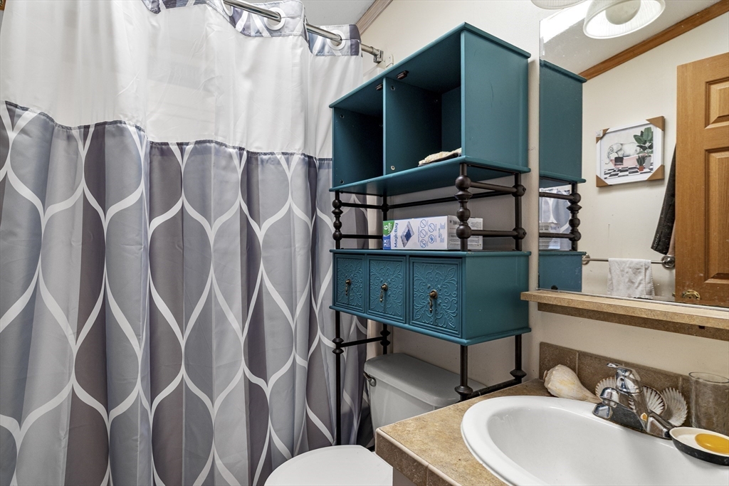 45 Kins Court Wareham, MA 02558 - Photo 15 of 16 a bathroom with a toilet sink and mirror