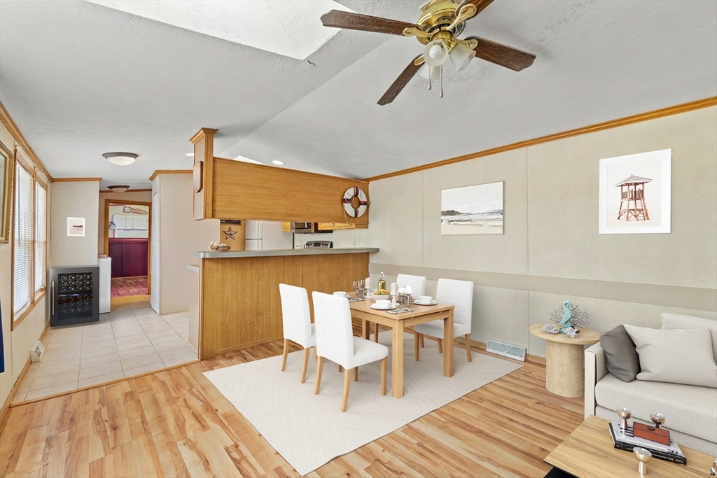 45 Kins Court Wareham, MA 02558 - Photo 7 of 16 a living room with furniture and a dining table with chandelier
