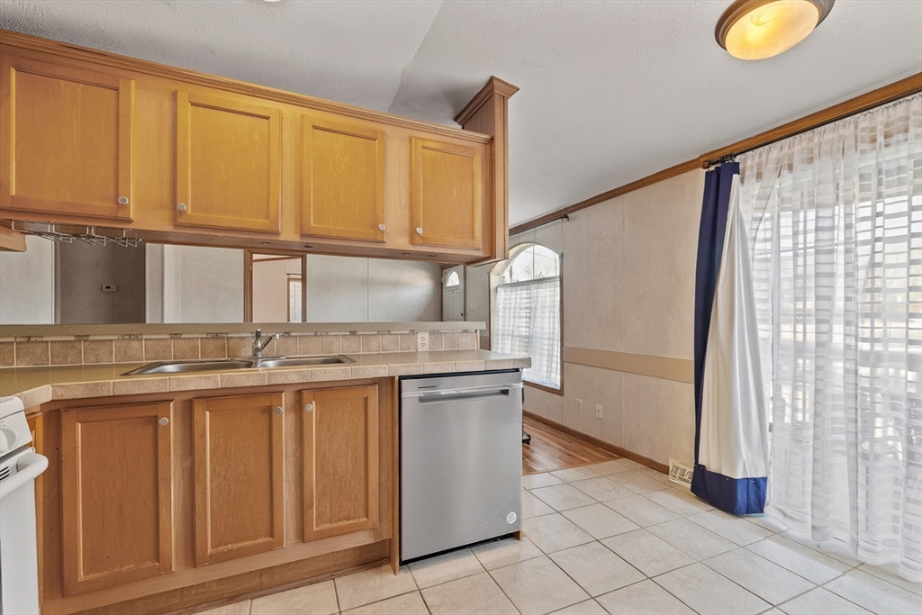 45 Kins Court Wareham, MA 02558 - Photo 8 of 16 a kitchen with stainless steel appliances granite countertop a sink and a cabinets