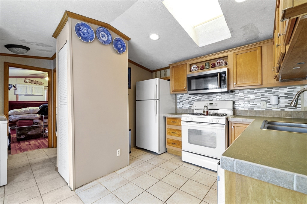 45 Kins Court Wareham, MA 02558 - Photo 9 of 16 a kitchen with stainless steel appliances granite countertop a refrigerator and a stove top oven