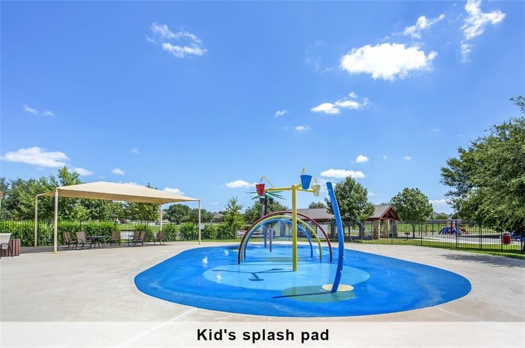 2109 Granite Springs Road Leander, TX 78641 - Photo 25 of 30 A vibrant splash pad offers endless fun on sun-drenched days, complemented by a shaded seating area for relaxation.