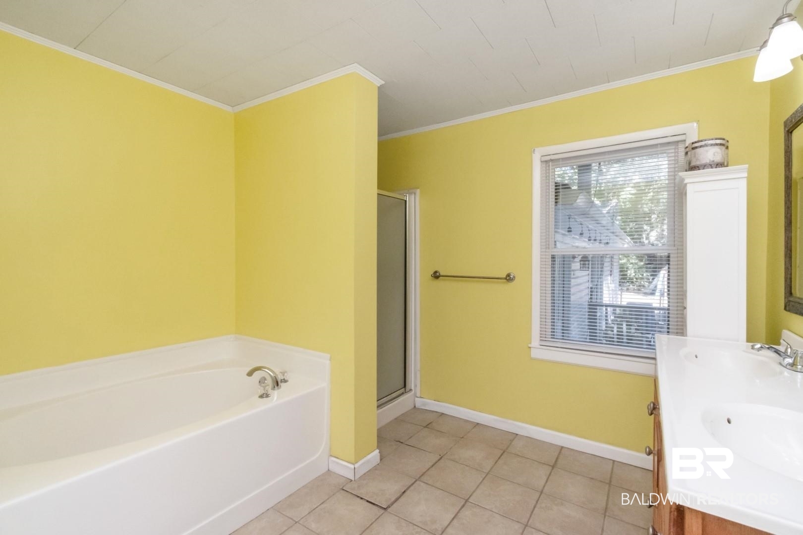 1321 Rainbow Drive West Mobile, AL 36693 - Photo 27 of 48 Bathroom featuring vanity, ornamental molding, shower with separate bathtub, and tile patterned flooring