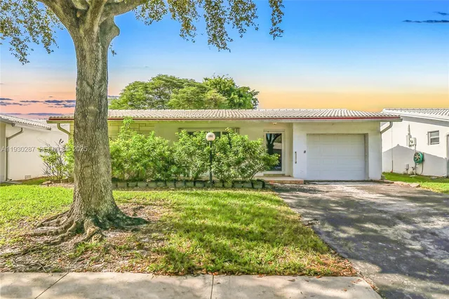a view of a house with a tree in a yard