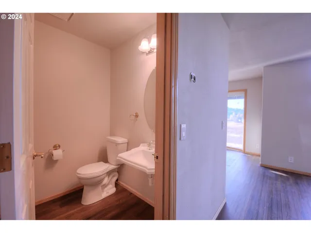 a bathroom with a toilet a sink and mirror