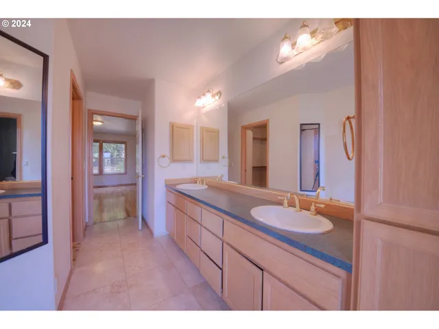 a bathroom with a granite countertop sink mirror and double