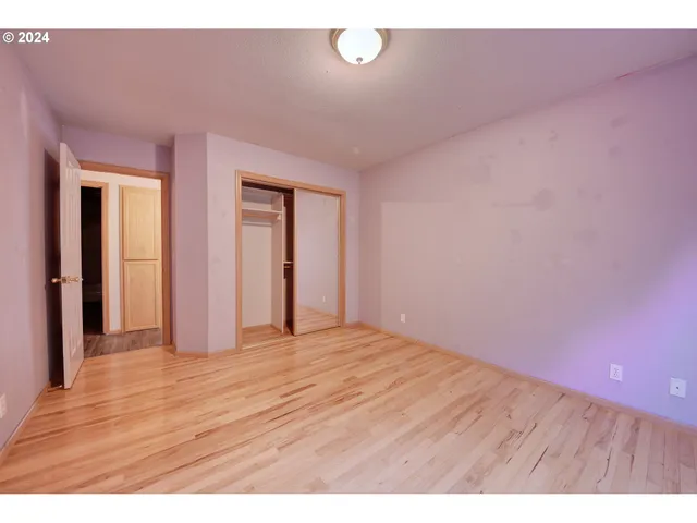 a view of an empty room and wooden floor