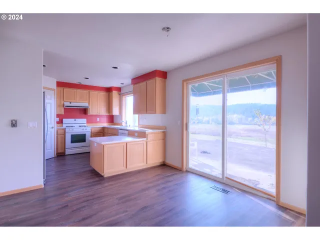 a room with wooden floors and windows