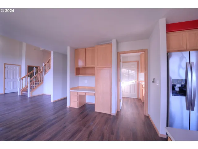 a empty room with wooden floor and a view