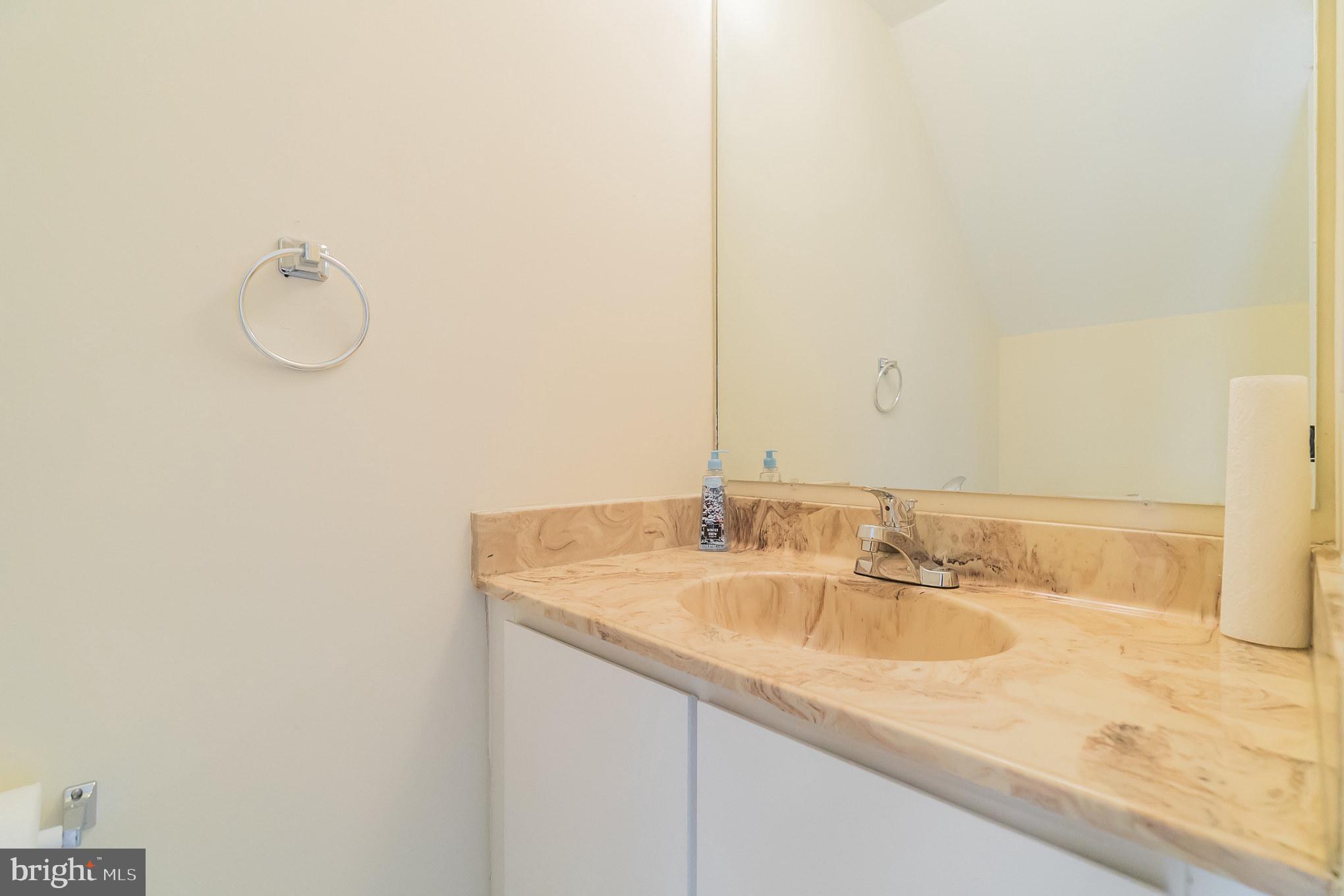414 Windsor Circle Exton, PA 19341 - Photo 11 of 28 a bathroom with a granite countertop sink and a mirror